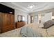 Spacious main bedroom with tray ceiling, fan, plush carpeting and wood armoire at 621 Aylestone Dr, Cary, NC 27519