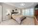 Spacious main bedroom with a tray ceiling, fan, neutral colors, and plush carpeting at 621 Aylestone Dr, Cary, NC 27519