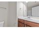 Bathroom with a single vanity, large mirror, overhead lighting, and tile flooring at 8323 Yaxley Hall Dr, Raleigh, NC 27616