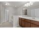 Bathroom featuring double sink vanity, large mirror, and a separate tub and shower at 8323 Yaxley Hall Dr, Raleigh, NC 27616