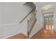 Inviting entryway featuring hardwood floors, a staircase with decorative iron railings, and neutral paint at 8323 Yaxley Hall Dr, Raleigh, NC 27616