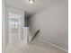 Upstairs hallway with carpet flooring and a view into a bedroom with natural light at 8323 Yaxley Hall Dr, Raleigh, NC 27616