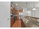 Well-equipped kitchen with granite counters, stainless steel appliances, wood cabinets, and bar top seating at 8323 Yaxley Hall Dr, Raleigh, NC 27616