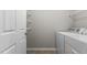 Laundry room with a washer and dryer with white wire shelving and a door at 8323 Yaxley Hall Dr, Raleigh, NC 27616