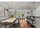 Open-concept living room with hardwood floors, natural light, and modern decor and bar area at 8323 Yaxley Hall Dr, Raleigh, NC 27616