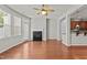 Inviting living room features a fireplace, wood floors, ceiling fan and natural light at 8323 Yaxley Hall Dr, Raleigh, NC 27616