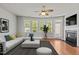 Bright and airy living room with large windows, hardwood floors, a ceiling fan, and a fireplace at 8323 Yaxley Hall Dr, Raleigh, NC 27616