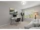 Home office with a desk, chair, modern decor, and a couch by the window at 8323 Yaxley Hall Dr, Raleigh, NC 27616