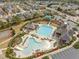 Aerial view of community pool with slides, ample seating, and a clubhouse at 8323 Yaxley Hall Dr, Raleigh, NC 27616