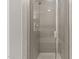 Shower stall featuring neutral tiles, glass door, and modern shower head fixture at 8323 Yaxley Hall Dr, Raleigh, NC 27616
