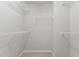 Walk-in closet with carpet and several rows of built-in white wire shelving at 8323 Yaxley Hall Dr, Raleigh, NC 27616