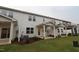 Exterior view of new construction townhome with landscaped backyard and covered patio at 912 Montague Ave, Durham, NC 27703