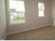 Bedroom features plush carpeting and natural light from two windows at 912 Montague Ave, Durham, NC 27703
