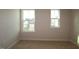Bedroom features plush carpeting and natural light from two windows at 912 Montague Ave, Durham, NC 27703