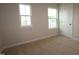 Bedroom features carpeted floors, white walls, and windows with natural light at 912 Montague Ave, Durham, NC 27703