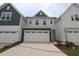 Traditional two-story home with white and blue painted siding and attached two-car garages at 912 Montague Ave, Durham, NC 27703
