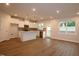 Open concept kitchen and living room with stainless appliances, granite counters and wood flooring at 912 Montague Ave, Durham, NC 27703