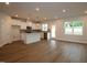 Open concept kitchen and living room with stainless appliances, granite counters and wood flooring at 912 Montague Ave, Durham, NC 27703