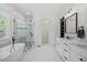 Bright bathroom with a free-standing tub, glass enclosed shower and dual sink vanity with marble countertops at 940 Rivers Edge Dr, Graham, NC 27253
