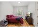 Cozy bedroom with hardwood floors, ceiling fan, and a large window at 940 Rivers Edge Dr, Graham, NC 27253
