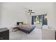 Bright bedroom featuring a ceiling fan, large window with curtains and playful bedding at 940 Rivers Edge Dr, Graham, NC 27253
