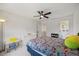 Well-lit ' bedroom with a ceiling fan, colorful bedding and a view to an organized closet at 940 Rivers Edge Dr, Graham, NC 27253