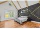 Unique bedroom with vaulted ceiling, hardwood floors and an eye catching feature wall at 940 Rivers Edge Dr, Graham, NC 27253