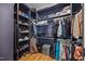 Spacious walk-in closet with custom shelving and hardwood floors at 940 Rivers Edge Dr, Graham, NC 27253