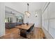 Elegant dining room with hardwood floors, modern light fixture, and large windows at 940 Rivers Edge Dr, Graham, NC 27253