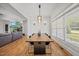 Bright dining area featuring hardwood floors, modern chandelier, and a large window at 940 Rivers Edge Dr, Graham, NC 27253