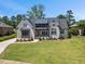 Stunning brick home with a modern design, dark roof, and well-manicured lawn at 940 Rivers Edge Dr, Graham, NC 27253