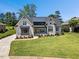 Gorgeous brick home features a well-kept lawn, modern windows and a stylish roof at 940 Rivers Edge Dr, Graham, NC 27253