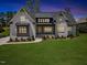 Charming home with a well-manicured lawn, white brick facade, and a welcoming front porch at 940 Rivers Edge Dr, Graham, NC 27253
