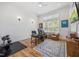 Bright office featuring hardwood floors, a large window, desk and a leather chair at 940 Rivers Edge Dr, Graham, NC 27253