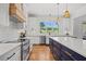 Well-appointed kitchen with island seating, stainless appliances, and a view of the backyard at 940 Rivers Edge Dr, Graham, NC 27253