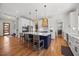Bright kitchen featuring a large island with seating, modern appliances, and hardwood flooring at 940 Rivers Edge Dr, Graham, NC 27253