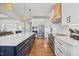 Open concept kitchen with a large island, stainless steel refrigerator, and view to the living area at 940 Rivers Edge Dr, Graham, NC 27253