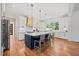 Bright modern kitchen with large island, stainless steel appliances and hardwood floors at 940 Rivers Edge Dr, Graham, NC 27253
