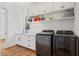 Functional laundry room with modern appliances, white cabinetry, sink, and workspace at 940 Rivers Edge Dr, Graham, NC 27253