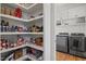 Well-organized pantry and laundry area with shelving and modern washer and dryer units at 940 Rivers Edge Dr, Graham, NC 27253