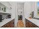 Convenient laundry room area with counter space and cabinets, adjacent to a laundry room with machines at 940 Rivers Edge Dr, Graham, NC 27253