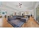 Open living space featuring hardwood floors, sectional sofa, and view to kitchen at 940 Rivers Edge Dr, Graham, NC 27253