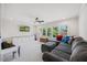 A spacious living room is brightened by natural light and is equipped with a large grey sectional at 940 Rivers Edge Dr, Graham, NC 27253