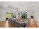 Spacious living room featuring hardwood floors, tray ceilings and a large sectional at 940 Rivers Edge Dr, Graham, NC 27253