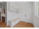 A convenient mudroom includes a bench with storage, hooks, and white shaker cabinets at 940 Rivers Edge Dr, Graham, NC 27253