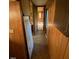 The hallway has wood paneling and is adjacent to the kitchen and living room at , Cameron, NC 28326