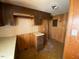 Galley kitchen with matching countertops, cabinets, and linoleum flooring at , Cameron, NC 28326