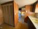 Galley kitchen has linoleum flooring, matching countertops, and dark cabinets at , Cameron, NC 28326