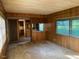 Living room with wood paneled walls and view of adjacent dining area at , Cameron, NC 28326