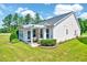 Beautiful backyard with green grass, patio, and home exterior at 1004 Sounding Ln, Durham, NC 27703